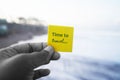 Person holding a yellow card with text in hand - Time to travel. Self reminder for recharge.