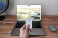 Person holds credit card in front of computer for online transaction Royalty Free Stock Photo