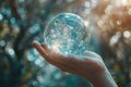 A person holds a crystal ball in their hand, gazing into its mystical depths for answers and insights