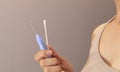 Person Holds Ear Wax Removal Glass Stick Or Curette With Led Light And Q-tip Cotton Swab