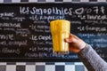 Person holds freshly prepared smoothie