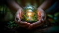 person holds a glass ball in the forest