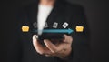 A person holds a smartphone displaying a digital transfer of documents between yellow folders, symbolizing seamless file sharing, Royalty Free Stock Photo