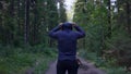 Person in a hood standing. Man in the hood in the woods. Sport in the forest on the nature Royalty Free Stock Photo