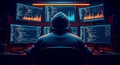 Anonymous hacker wearing hoodie working on multiple computer screens with financial data charts and coding interfaces at night Royalty Free Stock Photo