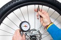 Inflating a bicycle wheel Royalty Free Stock Photo