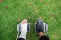 Person injured in a wheelchair. Foot and hand bandages, outdoor photography in a park