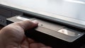 Person inserting an old VHS video cassette tape in a video recorder