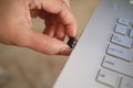 Person inserting plug in wireless bluetooth mouse or wifi dongle into usb port in laptop personal computer, data transfer device Royalty Free Stock Photo