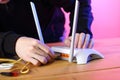 Person inserting into router internet cable port on table Royalty Free Stock Photo