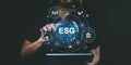 Person interacting with digital ESG interface on tablet. Dark ba Royalty Free Stock Photo