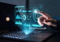 A person interacting with futuristic data analytics on a laptop screen Royalty Free Stock Photo