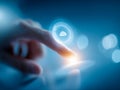 Person interacting with futuristic digital cloud storage icon projecting from a touchscreen device in a blue tech environment with Royalty Free Stock Photo