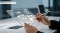 A person interacting with a futuristic transparent tablet on a desk in a modern office setting Royalty Free Stock Photo