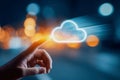 Person interacting with a glowing digital cloud icon representing data storage and cloud computing on a blurred futuristic Royalty Free Stock Photo