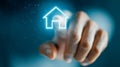 Person interacting with a glowing home icon in futuristic digital interface representing smart house technology and virtual real Royalty Free Stock Photo
