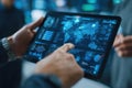 Person interacting with a tablet displaying complex digital data and futuristic analytics in a modern setting Royalty Free Stock Photo