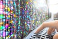 Person interacting with vibrant computational data interface visualization Royalty Free Stock Photo