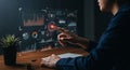 A person interacts with a digital interface displaying various data visualizations,