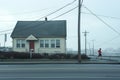 person jogging past a lone house on a city street in the morning Royalty Free Stock Photo