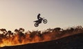 Person, jump and professional motorcyclist in the air on mockup for trick, stunt or ramp on outdoor dirt track. Expert Royalty Free Stock Photo