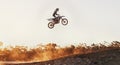 Person, jump and professional motorcyclist on mockup in the air for trick, stunt or ramp on outdoor dirt track. Expert Royalty Free Stock Photo