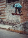 Person jumping with skateboard urban style mode