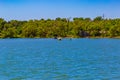 Person in a Kayak with an umbrella on a sunny day on the lake