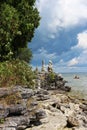 A person kayaking on Lake Michigan near a rocky shoreline with stacks of cairns at Cave Point County Park in Wisconsin Royalty Free Stock Photo