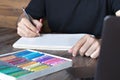 person learning online painting with pencil and pastel crayon on white sheet of paper in front of laptop on wooden table Royalty Free Stock Photo