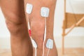 Person leg with electrodes on knee Royalty Free Stock Photo