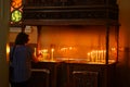 A person lights candles in the church Royalty Free Stock Photo