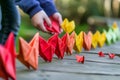 person lining up heart origamis for a photo shoot