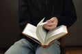 person is looking through a book on his lap