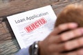 Person Looking At Rejected Loan Application