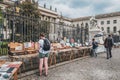 Person looking at second hand books for sale on flea market in front of the Humboldt University in Berlin Royalty Free Stock Photo