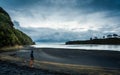 Person looking at thewater on a beach in New Zealand