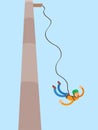 A person makes a jump with a rope from the tower.