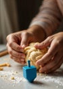 a person is making a challah dough ball with a blue dreidel Royalty Free Stock Photo