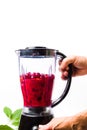 Person making cherry smoothie with a blender Royalty Free Stock Photo