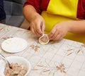 A person is making a dumpling on a table Royalty Free Stock Photo