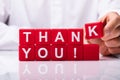 Person Making Thank You Text With Red Cubic Blocks Royalty Free Stock Photo