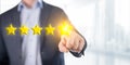 Person man pointing on 5 star review, costumer feedback concept - five stars rating. Feedback, reputation and quality concept. Royalty Free Stock Photo