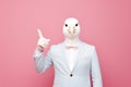 Person with a mask. Man wearing white suit and funny pigeon bird mask. Royalty Free Stock Photo