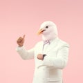 Person with a mask. Man wearing white suit and funny pigeon bird mask. Royalty Free Stock Photo