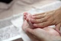 Person massaging the newborn foot