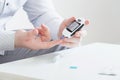 the person measures blood sugar with glucometer