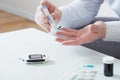 the person measures blood sugar with glucometer