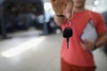 Person mechanic handing over key to car in workshop Royalty Free Stock Photo