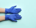 Person in medical gloves on light blue background, top view. Space for text Royalty Free Stock Photo
